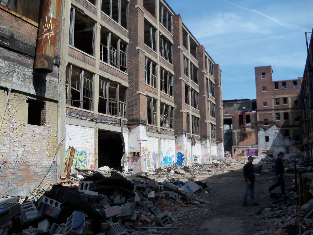 Geography and Sustainable Planning students walk through the abandoned Packard automobile factory grounds during field trip to Detroit.